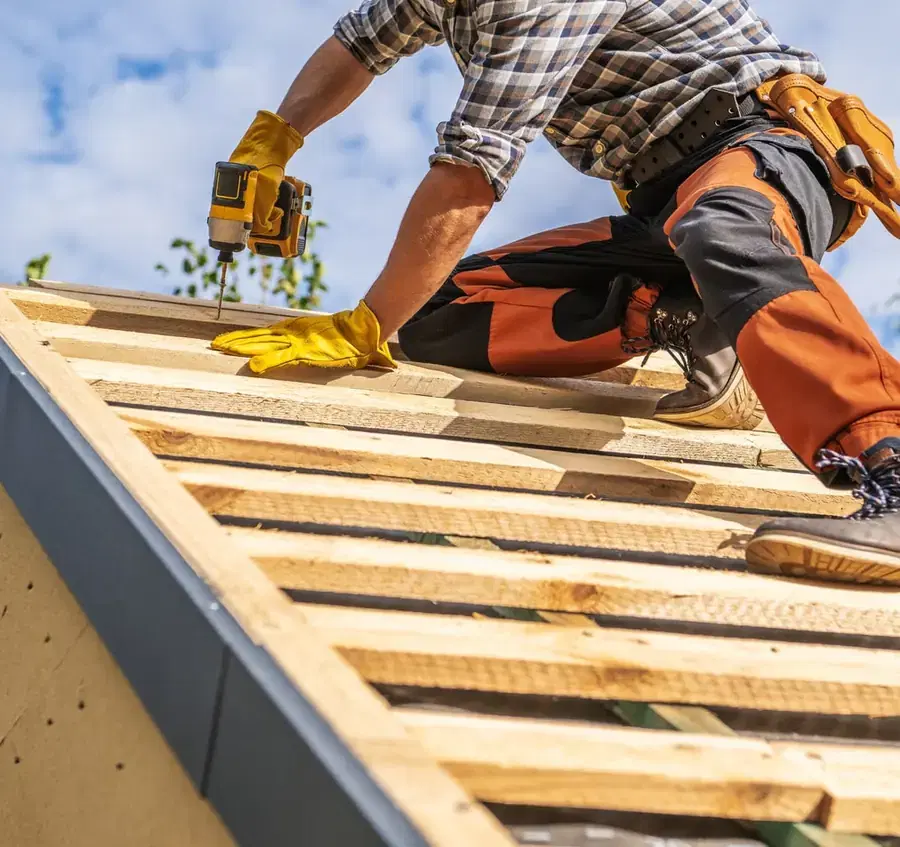 Tradesperson working on a timber roof. Illustrative photograph.